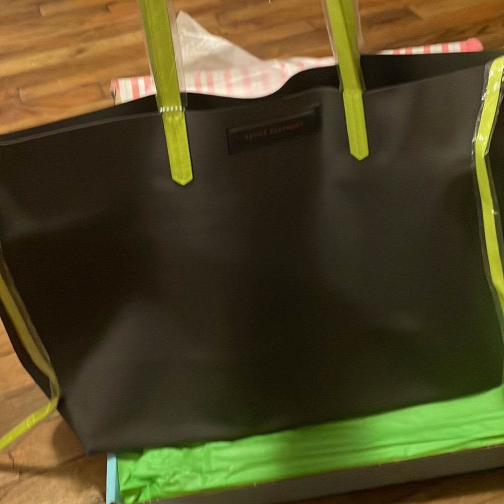 Inside pocket on this roomy tote. Good for travel easy access, With Closure ties